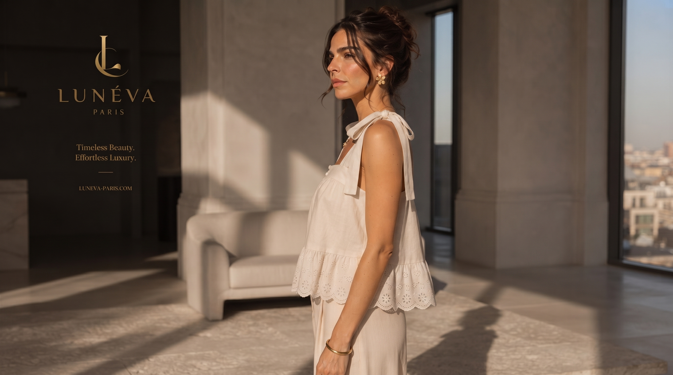 Side profile of the cream top showing the relaxed silhouette and scalloped eyelet hem